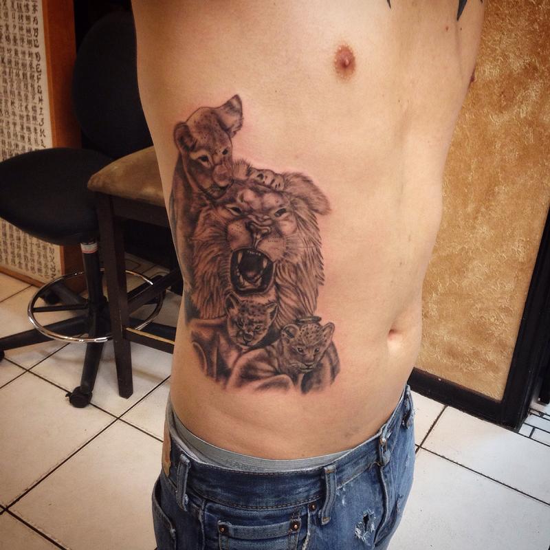 Black Ink Lion With Cubs Tattoo On Man Side Rib