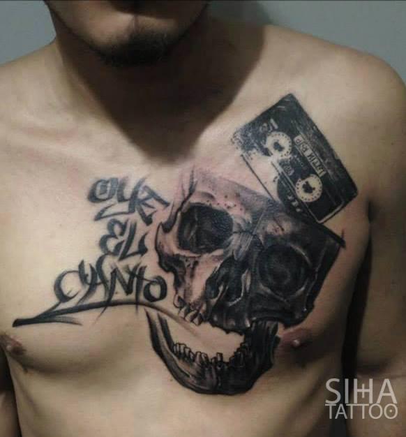 Black Ink Skull With Cassette Tattoo On Man Chest By Siha