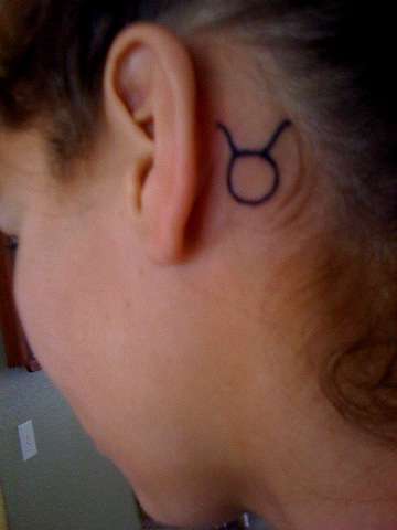 Black Taurus Symbol Tattoo On Behind The Ear