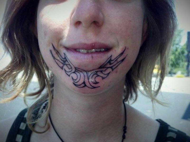 Black Tribal Design Tattoo On Girl Chin