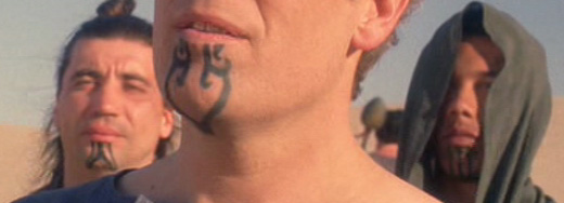 Black Tribal Heart Tattoo On Man Chin