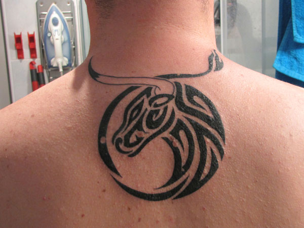 Black Tribal Taurus Head Tattoo On Upper Back