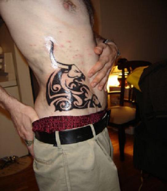 Black Tribal Taurus Tattoo On Man Side Rib