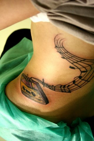 Cassette With Music Knots Tattoo On Side Rib
