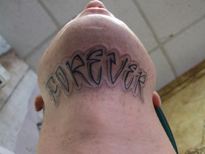 Forever Lettering Tattoo On Lower Chin
