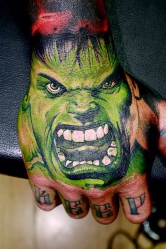 Green Ink Hulk Face Tattoo On Hand