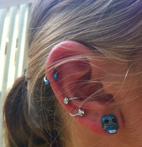 Lobe Piercing With Sugar Skull Stud And Spiral Conch Piercing