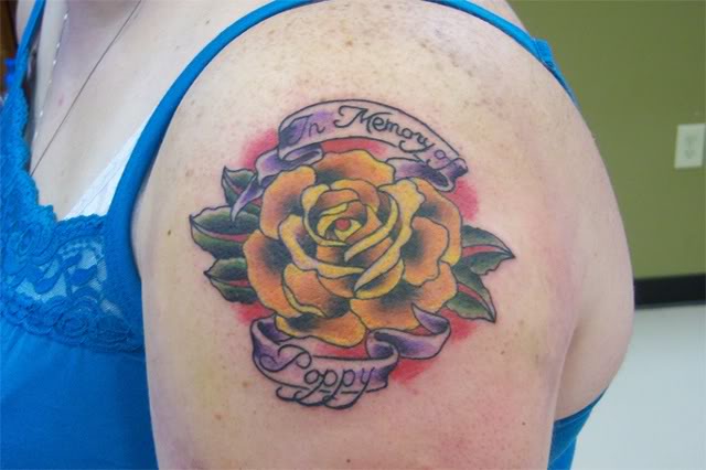 Orange Rose With Banner Tattoo On Girl Left Shoulder