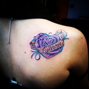 Purple Rose With Banner Tattoo On Right Back Shoulder