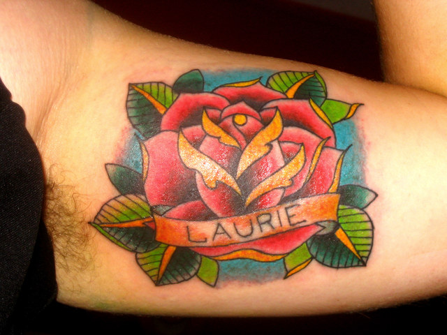 Red And Orange Rose With Banner Tattoo On Bicep