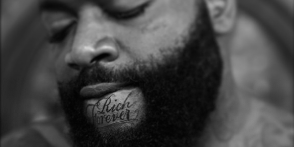 Rich Forever Lettering Tattoo On Man Chin