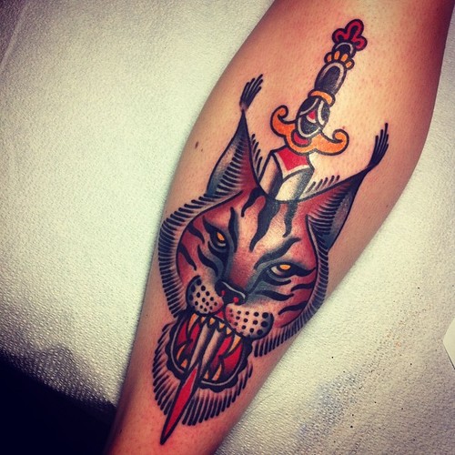 Traditional Dagger In Bobcat Head Tattoo On Forearm