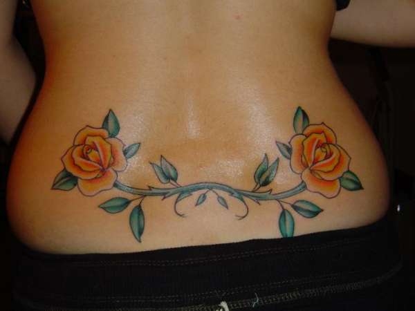 Two Orange Roses With Vine Tattoo On Lower Back