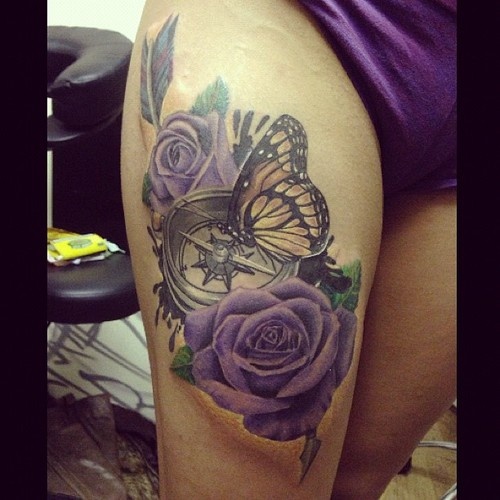 Two Purple Roses With Compass And Butterfly Tattoo On Right Thigh