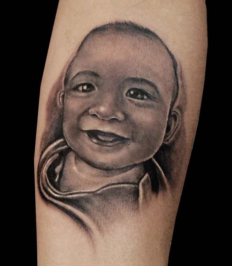 Amazing Black And Grey Baby Portrait Tattoo Design By Butch Rosca
