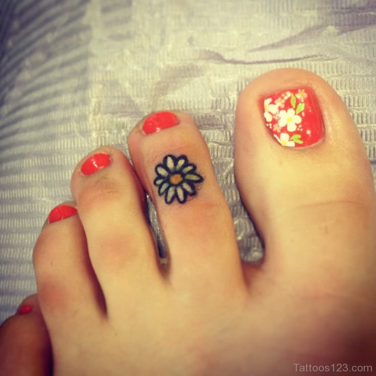 Amazing Little Flower Tattoo On Girl Foot Finger
