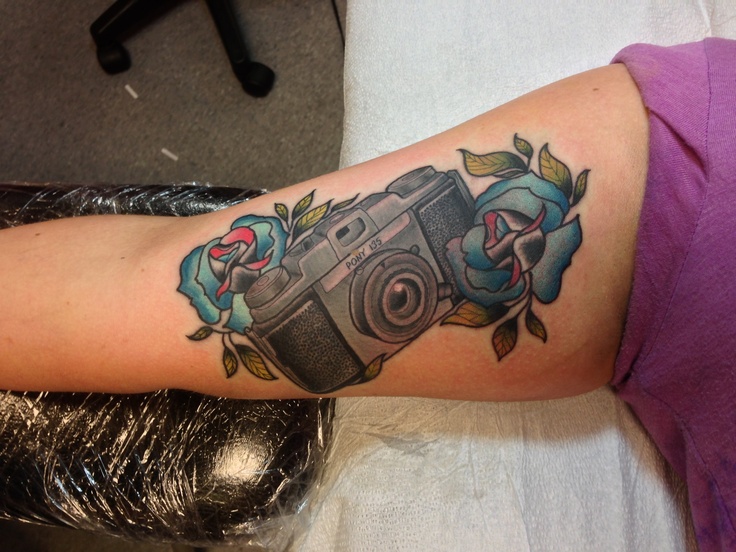Awesome 3D Camera With Flowers Tattoo On Half Sleeve By Garrett Duffin