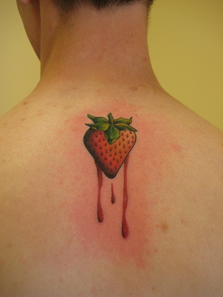 Awesome Strawberry Tattoo On Man Upper Back By Shannon Archuleta