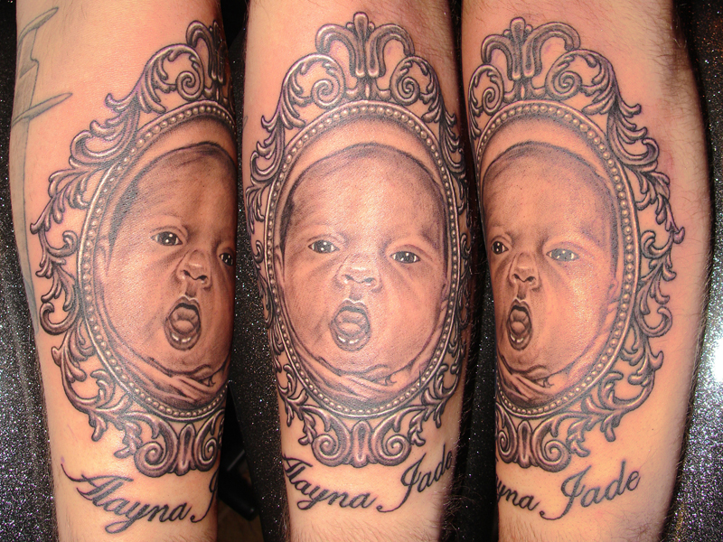 Baby Portrait In Frame Tattoo Design For Arm By Andrew Sussman