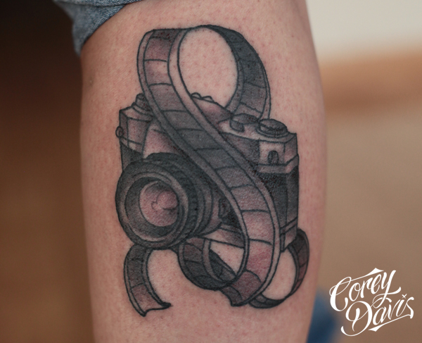 Black And Grey Camera With Filmstrip Tattoo For Leg By Corey Davis