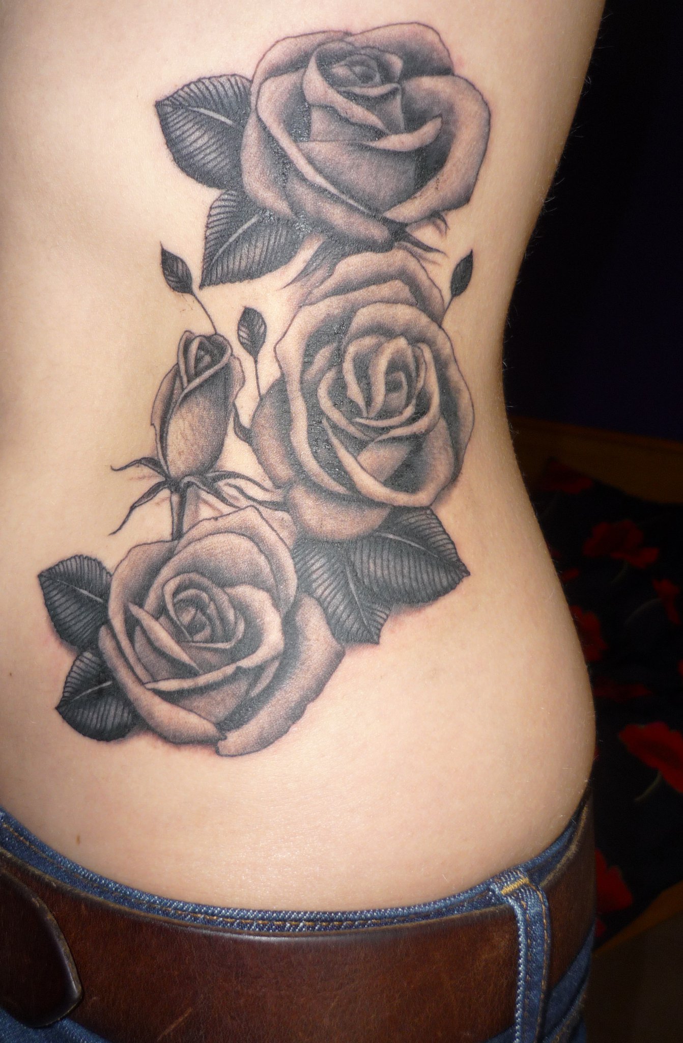 Black And Grey Three Roses Flowers Tattoo Design For Side Rib
