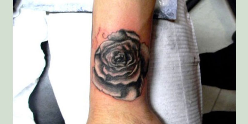 Black And White Rose Tattoo On Upper Wrist