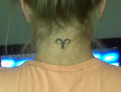 Black Aries Symbol Tattoo On Girl Back Neck