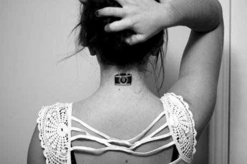 Black Camera Tattoo On Girl Back Neck