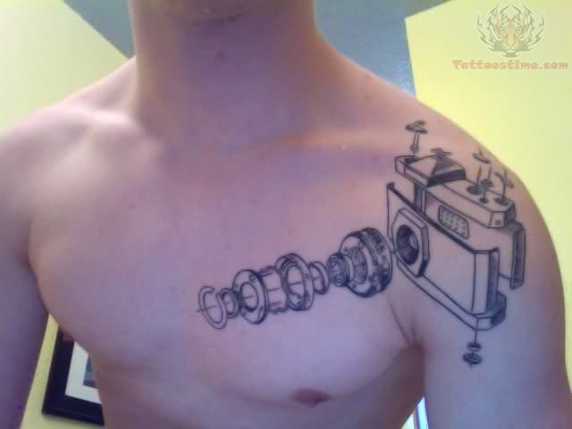 Black Disassemble Camera Tattoo On Man Left Chest And Shoulder