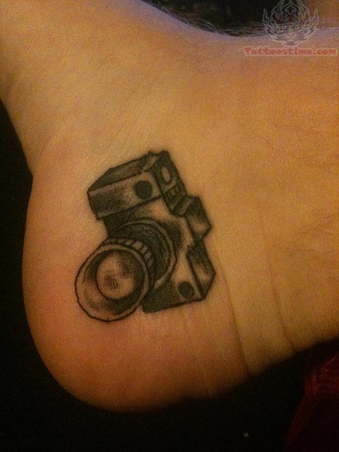 Black Ink Camera Tattoo On Heel