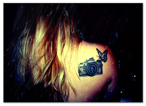 Black Ink Camera With Butterfly Tattoo On Girl Right Back Shoulder