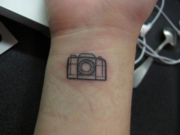 Black Little Camera Tattoo On Wrist