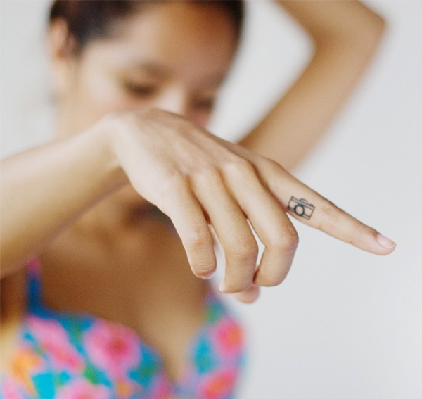 Black Outline Camera Tattoo On Girl Finger