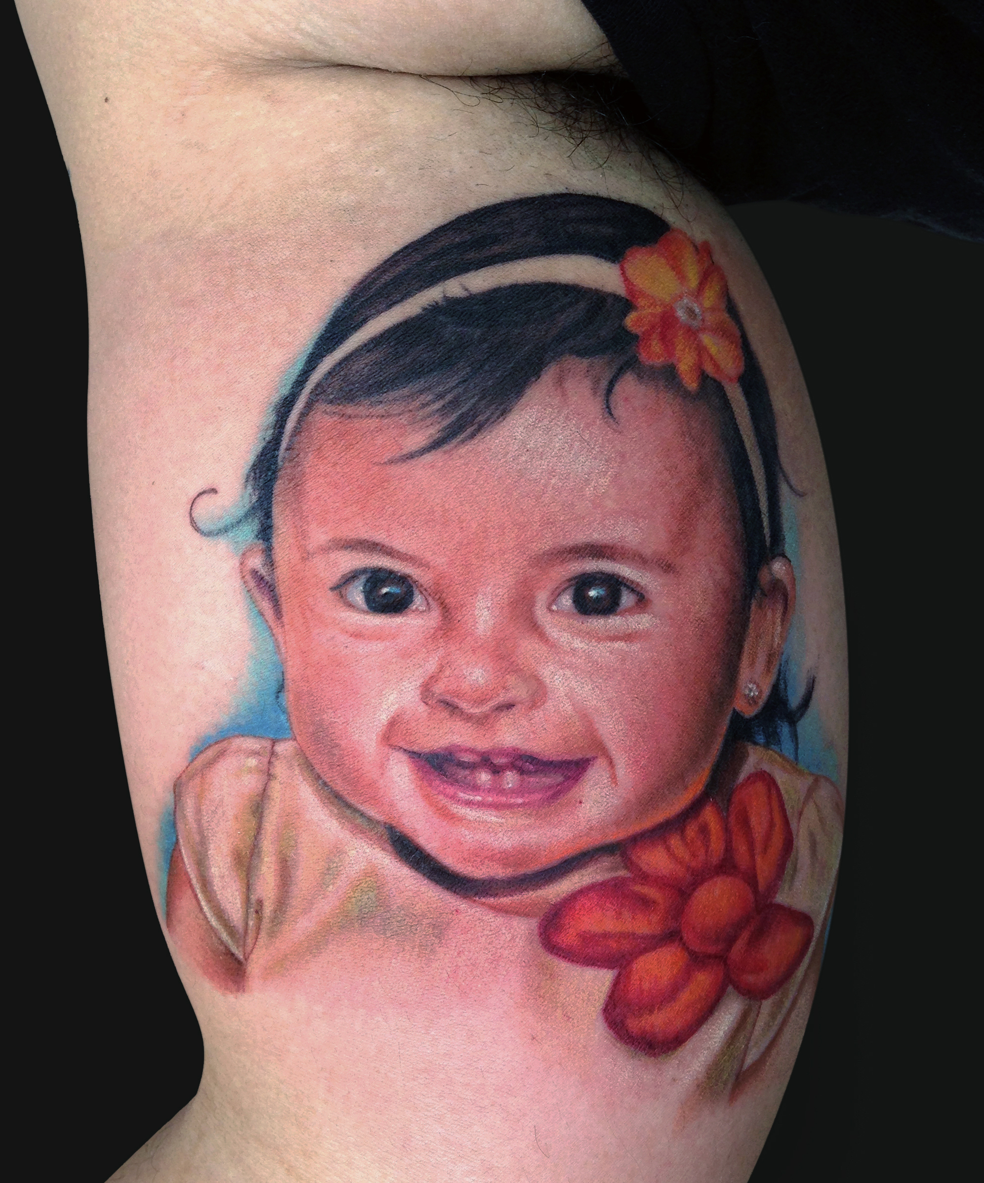 Colorful Baby Girl Portrait Tattoo On Bicep