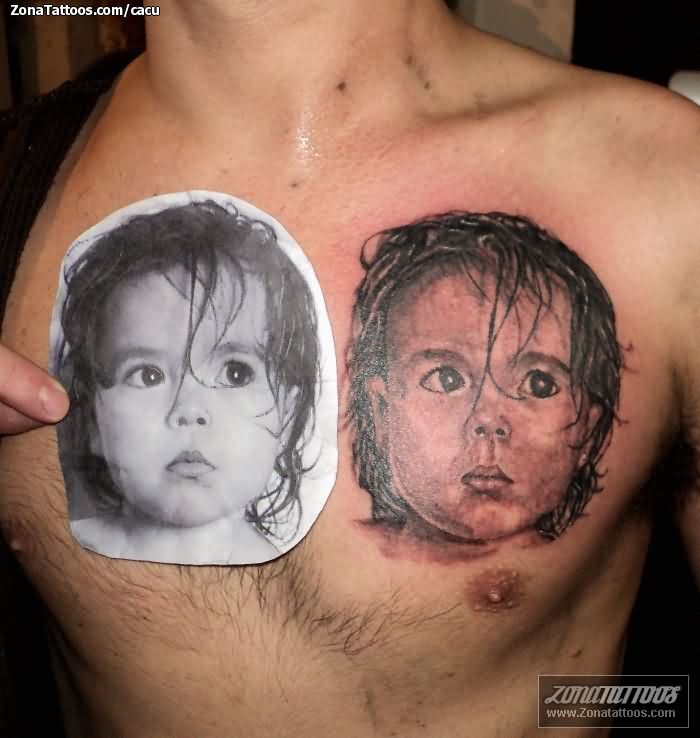 Realistic Baby Face Portrait Tattoo On Man Chest