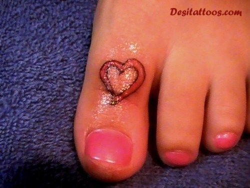 Red Ink Heart Tattoo On Girl Toe