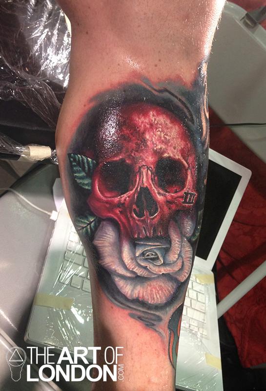 Red Ink Skull With White Rose Tattoo On Leg Calf