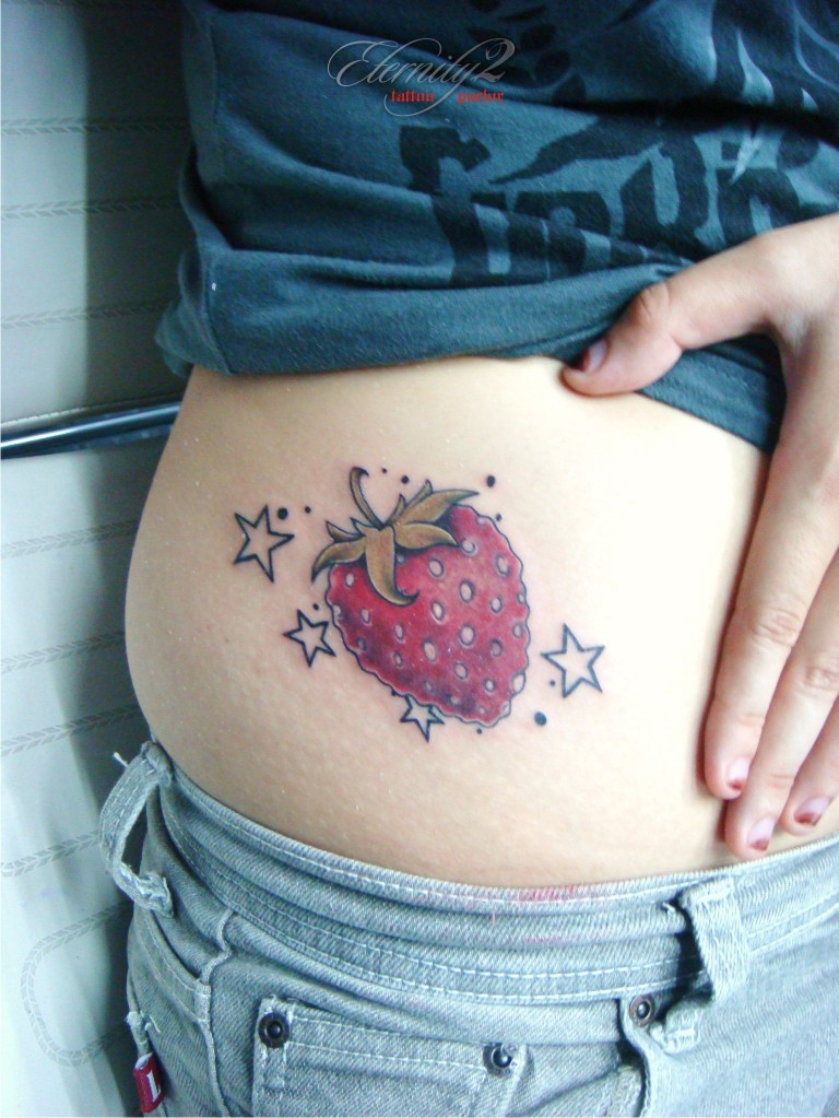 Strawberry With Stars Tattoo On Girl Side Rib By Eric Agathon