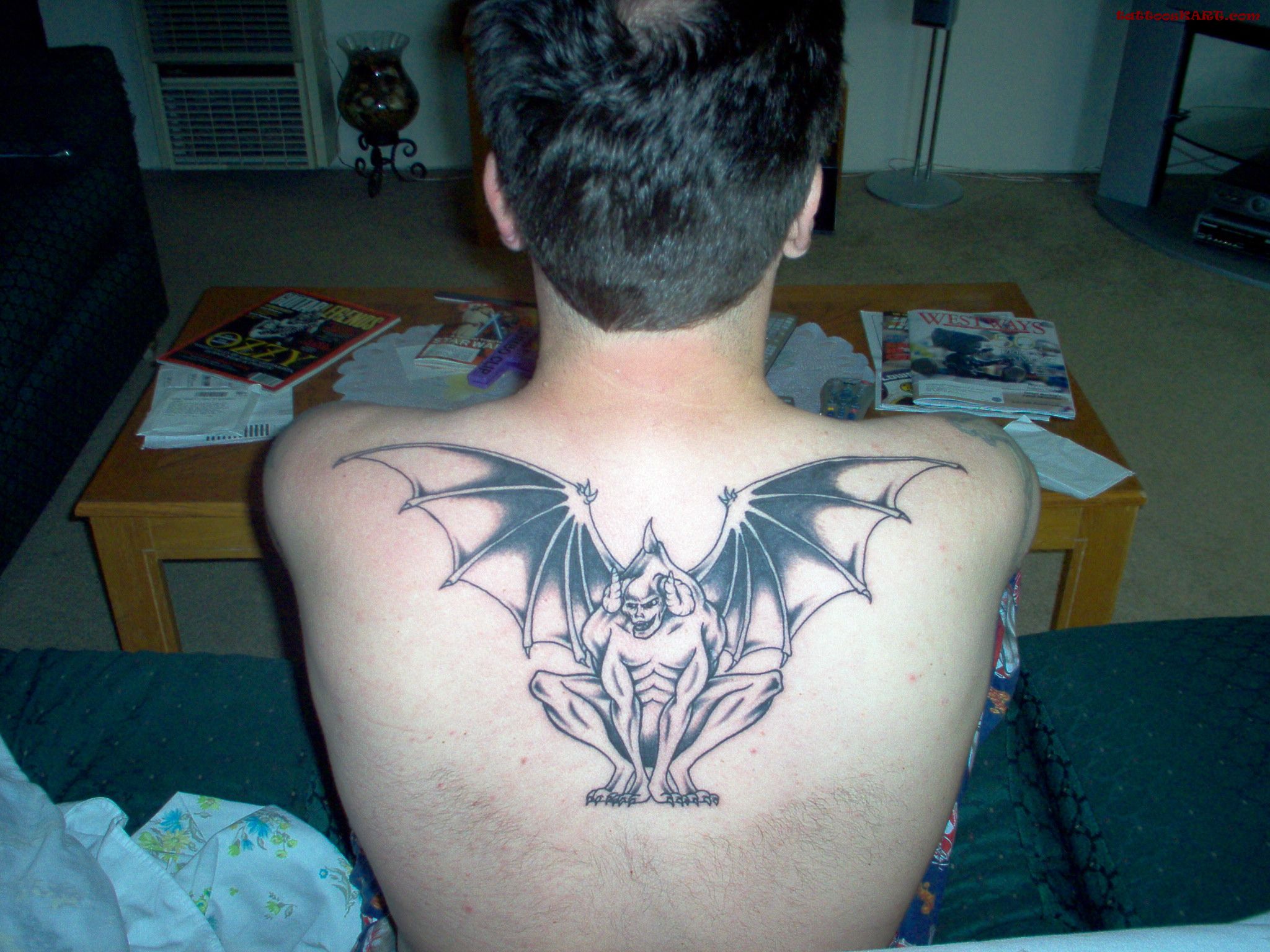 Unique Black Ink Gargoyle Tattoo On Man Upper Back