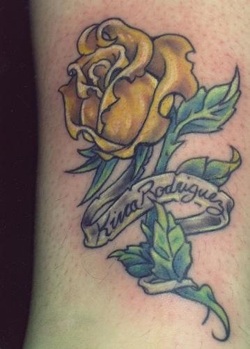 Yellow Rose With Leaves And Banner Tattoo Design