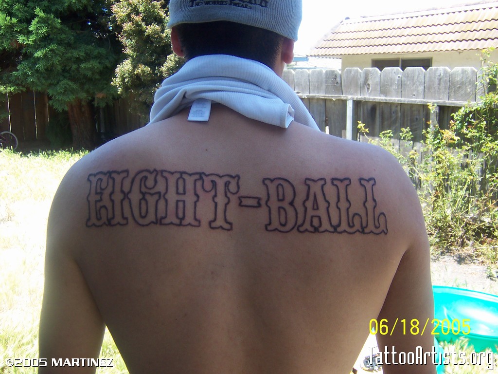 Amazing Eight Ball Lettering Tattoo On Man Upper Back