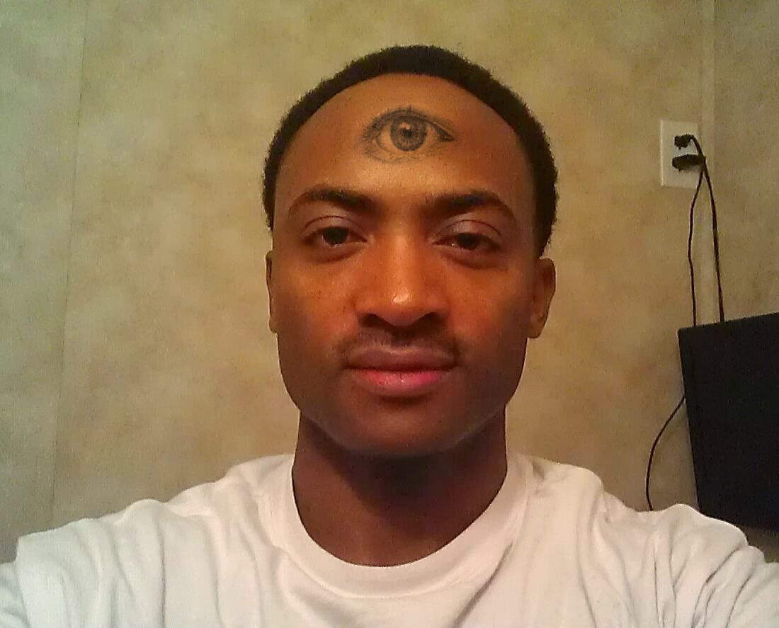 Black And Grey Eyeball Tattoo On Man Forehead