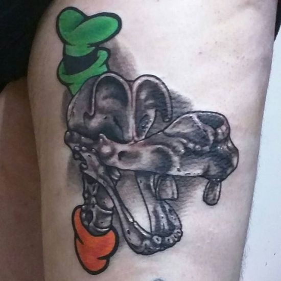 Black Ink Disney Goofy Skull Tattoo On Thigh