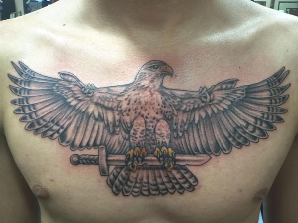 Black Ink Falcon Tattoo On Man Chest
