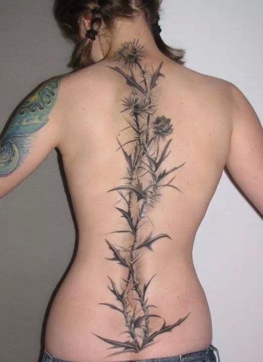 Black Ink Flowers With Thorns Tattoo On Girl Full Back
