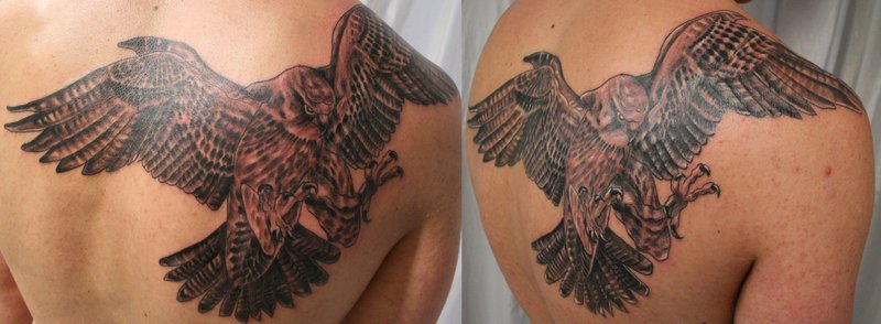 Black Ink Flying Falcon Tattoo On Upper Back By 2Face