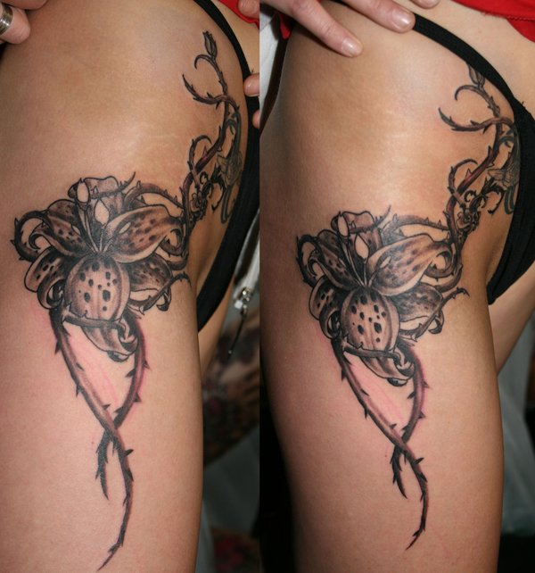 Black Ink Lily Flower With Thorns Tattoo On Thigh By 2Face