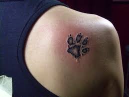Black Ink Pug Paw Tattoo On Right Back Shoulder