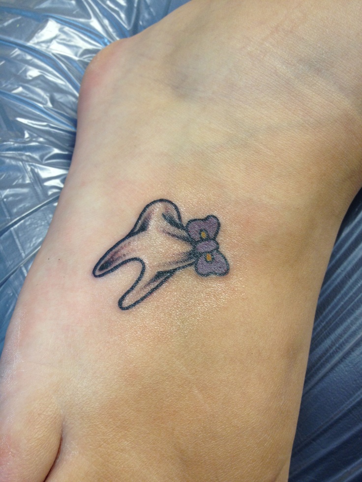 Black Ink Teeth With Bow Tattoo On Foot