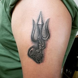 Black Ink Trishul With Pellet Drum Tattoo On Left Shoulder